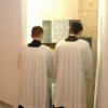Klerycy wkładają trumienkę do grobu